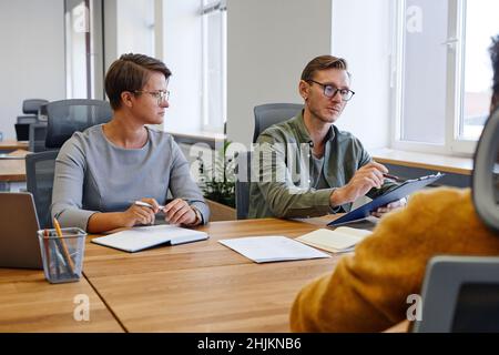 Portrait of two HR managers interviewing new employee for job position, copy space Stock Photo