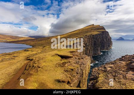 View of the Slave Cliff and Leitisvatn Lake on Vagar Island. Beautiful landscape. Faroe Islands. Stock Photo