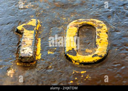 A number ten yellow on a bollard in the dock Stock Photo