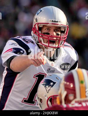 New England Patriots quarterback Tom Brady (12) hands off to running back  BenJarvus Green-Ellis (42) in fourth quarter action against the Washington  Redskins at FedEx Field in Landover, Maryland on Sunday December