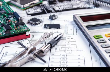 Electronic board, calculator, tweezers and photomask on background of  schematic circuit diagram. Concept for development and design of electronic dev Stock Photo