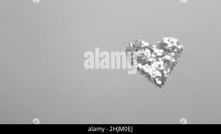 Heart made of sequins on a table. Copy space. BW photo Stock Photo