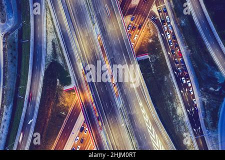 Top down perspective of road junction, crossroads aerial view. Transport industry toned image. Stock Photo