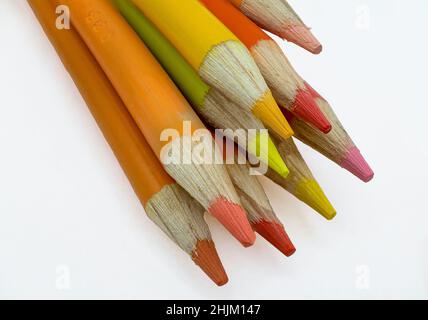 Colored wooden sharp pencils on a white background. Stock Photo