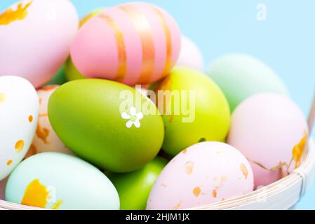 Easter basket filled with painted Easter eggs. Colorful painted Easter eggs in basket. Stock Photo