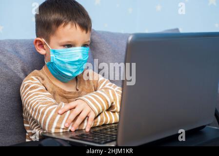Distance learning online education. A schoolboy boy studies at home and does his school homework. A home distance learning Stock Photo
