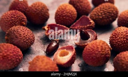 Litchi or Chinese plum on the table with black background. Stock Photo