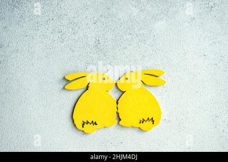 Easter card concept with bright colored wooden bunny as a holiday decorations Stock Photo