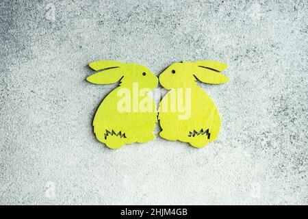 Easter card concept with bright colored wooden bunny as a holiday decorations Stock Photo