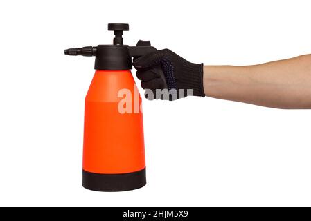 A mans hand holds hand-pumped sprayer isolated on white background. Garden pressure sprayer for dispensing fertilizer, pesticide or herbicide. Garden Stock Photo