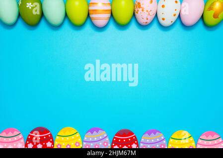 Easter Eggs. Colorful Easter eggs on blue background with copy space. Stock Photo