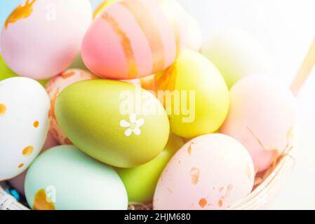 Easter basket filled with painted Easter eggs. Colorful painted Easter eggs in basket. Stock Photo