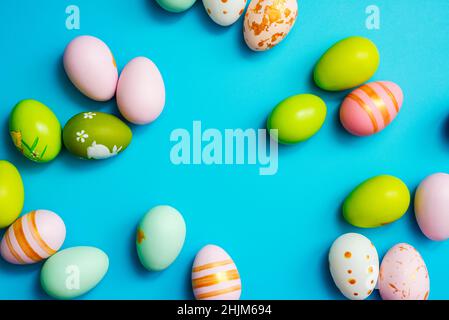Easter Eggs. Colorful Easter eggs on blue background with copy space. Stock Photo