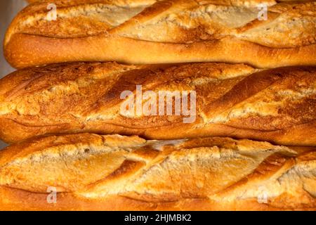 A closeup background of smaller French bread baguettes. Stock Photo