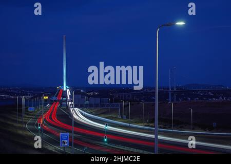 Highway leading to the big bridge and lights from cars at night. Queensferry Crossing, Scotland, United Kingdom Stock Photo