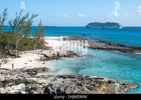 The aerial view of Half Moon Cay rocky beach and a cruise ship drifting in a background. Stock Photo