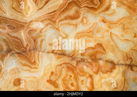 cut and polished tan sandstone background with lines and a crack Stock Photo