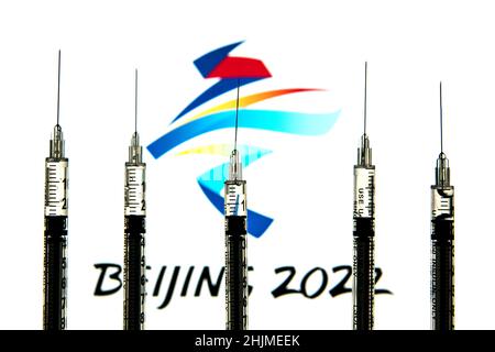 Spain. 24th Jan, 2022. In this photo illustration medical syringes seen with a Winter Olympics Games Beijing 2022 logo in the background. (Photo by Thiago Prudencio/SOPA Images/Sipa USA) Credit: Sipa USA/Alamy Live News Stock Photo