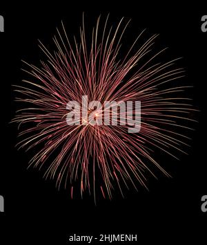 orange and red fireworks exploding in a black sky Stock Photo