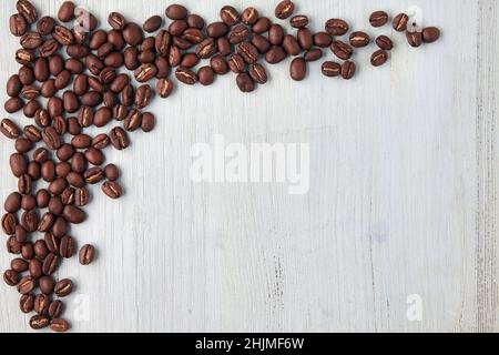 Designer frame made of coffee beans on a blue wooden table Stock Photo