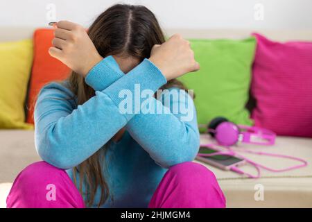 Teenage depression. Sad teenager feeling bad alone, feeling depressed  in quarantine Stock Photo