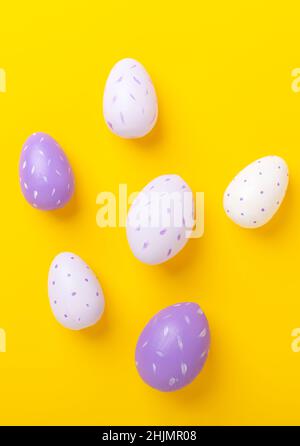 Multicolored easter eggs on yellow background. Easter concept. Top view. Copy space Stock Photo