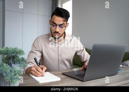 Young man student study on laptop in online college class from home office Stock Photo