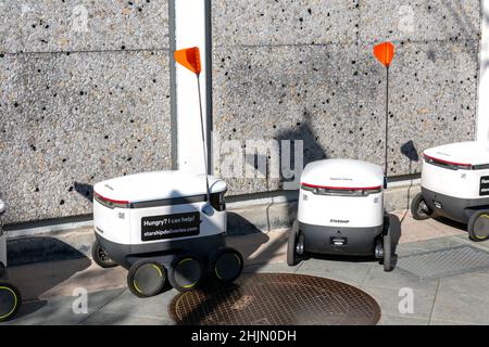 Starship food delivery automatic robots by Starship Technologies, waiting on parking near grocery store - San Jose, California, USA - 2022 Stock Photo