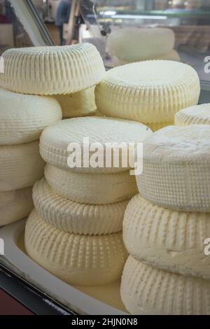 Closeup of piles of round homemade traditional soft cheese in the market in Georgia. Stock Photo