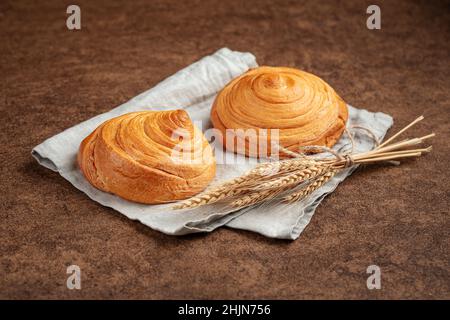 Fresh baked puff pastry buns on napkin Stock Photo
