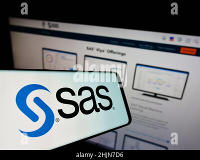 Smartphone with logo of American analytics software company SAS Institute Inc. on screen in front of website. Focus on center of phone display. Stock Photo