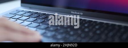 Minsk, Belarus, October 11, 2021: Woman uses an Apple Macbook Air Stock Photo