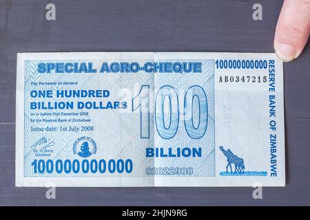 Zimbabwe currency money paper note of one hundred billion dollars close up photo of 2008 failed financial economic management for global record