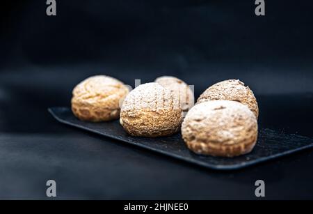 Appetizing Shu cakes on a black background. Stock Photo