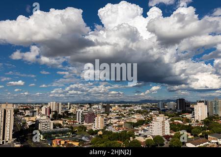 Aerial shot of the city of Sao Jose dos Pinhais in Brazil under big fluffy clouds Stock Photo