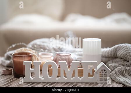 Close up decorative word home on blurred background with candles. Stock Photo