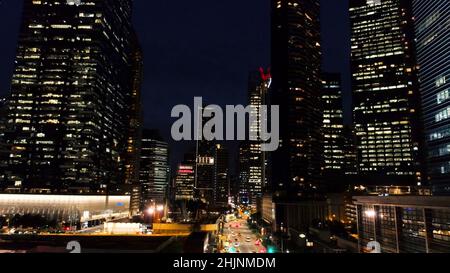 Exterior picturesque modern skyscrapers with glowing windows of offices in evening. Shot. The concept of nightlife in metropolis. Top view of offices Stock Photo