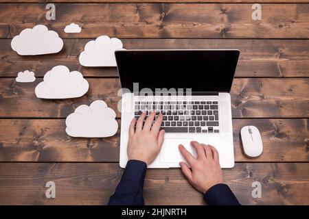 Hands working on an office laptop with cloud storage concept Stock Photo
