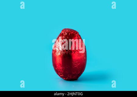 Red Easter egg on blue background Stock Photo