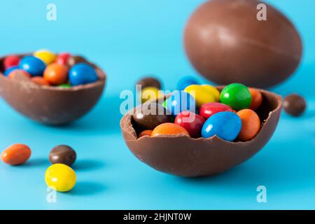 Colorful chocolate Easter eggs on blue bckground Stock Photo