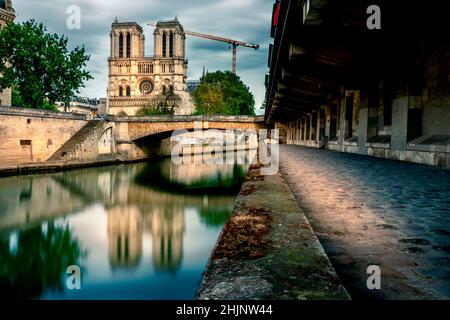 Paris, France - May 12, 2021: View of Notre Dame Cathedral from the banks of the Seine. A fire severely damaged the Cathedral in 2019 Stock Photo