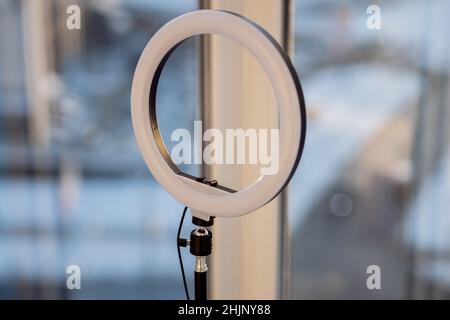 Close -up ring lamp in room at home or office. Equipment for blogging and recording video broadcast Stock Photo
