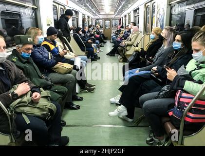 Moscow, Russia, October 2020: Passengers in protective masks in a subway car. The rules of the city during a pandemic. Stock Photo