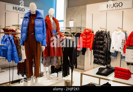 Moscow, Russia, November 2020: Corner of the Hugo Boss brand. Women's fashion. Luxury brand. Mannequins are dressed in winter collection clothes. Stock Photo