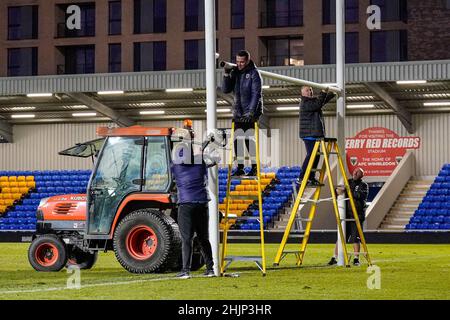 Wimbledon, UK. 19th Jan, 2022. Ground staff dismantle the rugby posts after the Betfred Championship match between London Broncos and Widnes Vikings at the Cherry Red Records Stadium, Plough Lane, Wimbledon, England on 30 January 2022. Photo by David Horn. Credit: PRiME Media Images/Alamy Live News Stock Photo