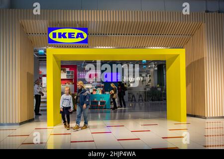 Moscow, Russia, September 2019: Entrance to the IKEA store. Come out blonde mom with a daughter who is unhappy. Stock Photo