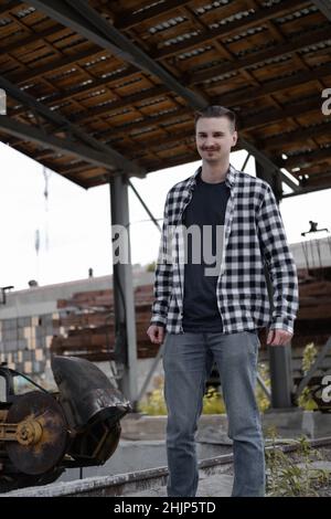 Portrait of man with mustache in checkered black and white shirt outside. Stock Photo