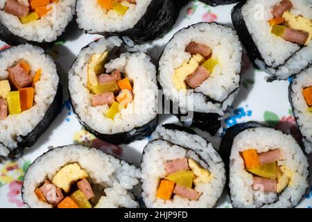 Homemade Korean kimbap or Japanese sushi rolls on a plate seen from above. Stock Photo
