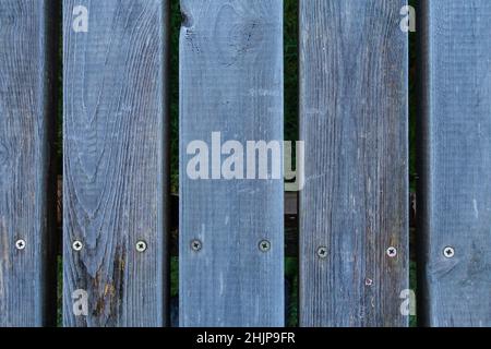 Frosted parallel wooden planks making up an outdoor table top. Stock Photo