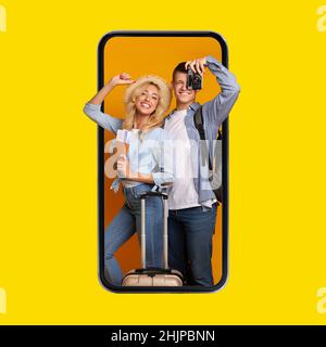 Couple Of Tourists In Phone Screen Posing Over Yellow Background Stock Photo